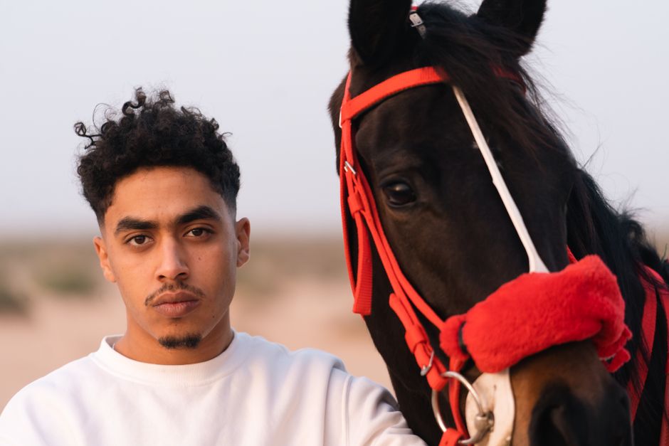A young man with an Arabian horse in Al-Hammah, Tunisia.
