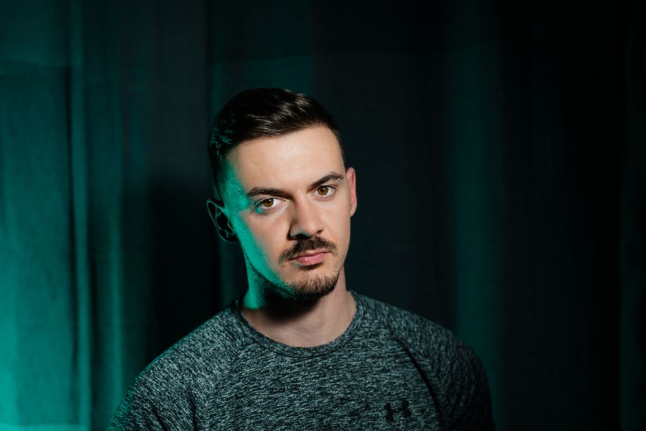 Studio portrait of a man with dark green artistic background, Galanta, Slovakia.